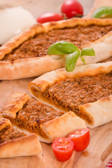 Turkish pide pizza with meat and onion.
