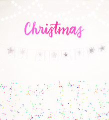 Christmas decoration with snow garland and confetti falling with silver color bokeh light garland best holiday image