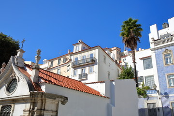 Colorful facades in Alfama neighborhood with a Russian Orthodox Church (Ortodoxa Russa) in the foreground, Lisbon, Portugal