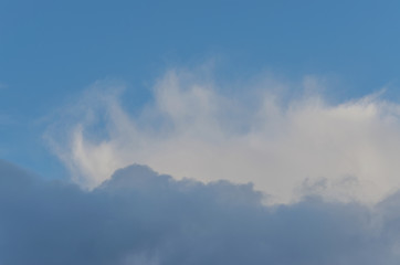 Naklejka na ściany i meble A blue sky with grey and white clouds