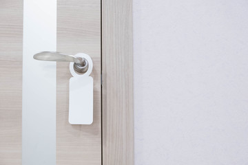 Empty label on a door handle for your text. door do not disturb sign.