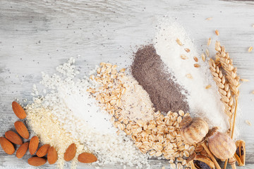Various types of flours on wooden table