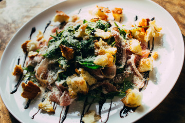 Salad. concept of lunch, view of old background. salad with croutons and sauce