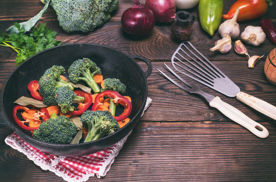 Fresh vegetables in a cast-iron black frying pan