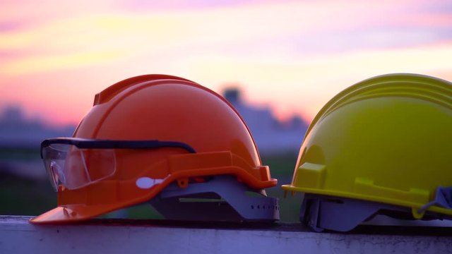 Panning shot of Construction helmet at sunset