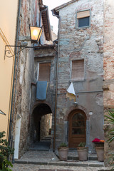 Fototapeta na wymiar Antique Italian Architecture: House with Stone Facade, Lamp and Stone Flooring