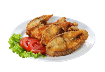 fried fish with vegetable on white