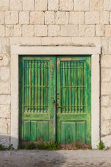 Fototapeta na wymiar Rusty door and stone wall