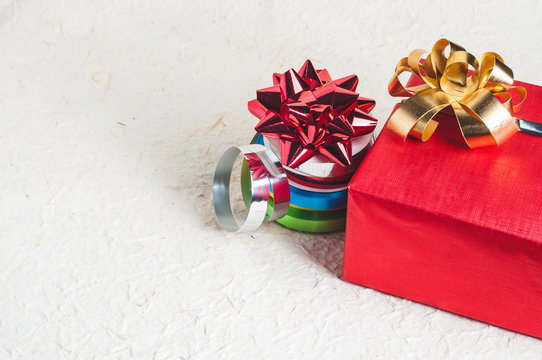 Christmas gift set for packing. Colorful ribbon and bow on textured background with empty space for your design