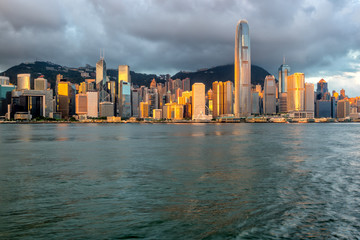 Naklejka premium Hong Kong City skyline at sunrise. View from across Victoria Harbor Hongkong.