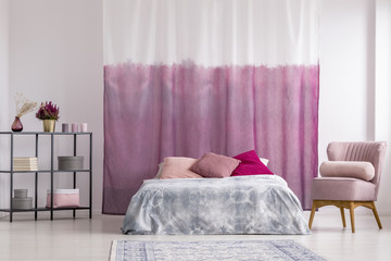 Pink armchair in girl's bedroom