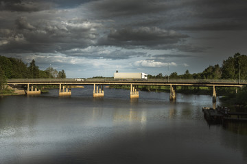 Fototapeta na wymiar Traffic over water on a concrete bridge