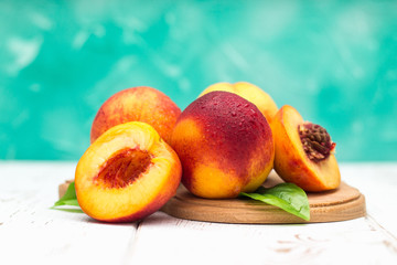 a lot of fresh peaches on a white table.