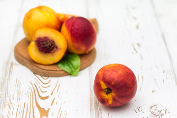Fototapeta na wymiar a lot of fresh peaches on a white table.