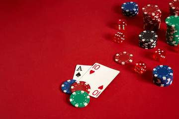 Poker cards and gambling chips on red background