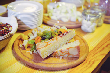 Cutting cheese, cheese is cut at a banquet, home cooking, close-up