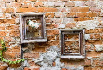 Frames on old brick wall