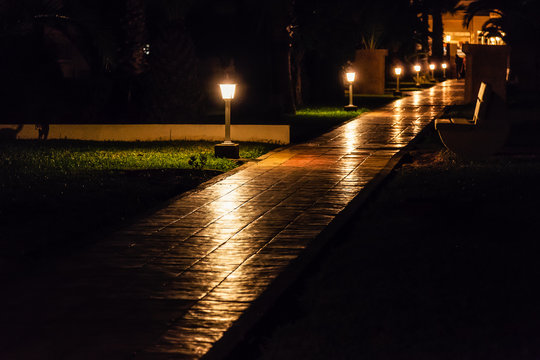 Night track with lanterns and bench