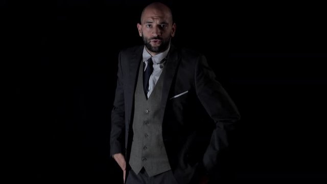 slow motion of a skillful male dancer in a smart suit dancing in a contemporary style.
