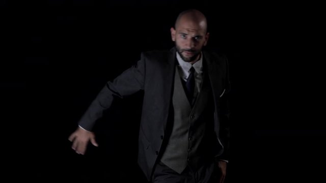 slow motion of a skillful male dancer in a smart suit dancing in a contemporary style.