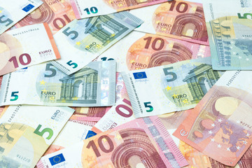 Stack of five and ten euro banknotes background.