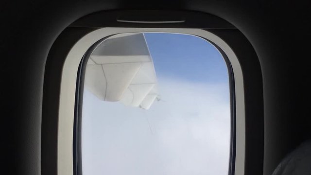 View from the passenger's Window Watching the Cloud High in the Sky on an Aeroplane 