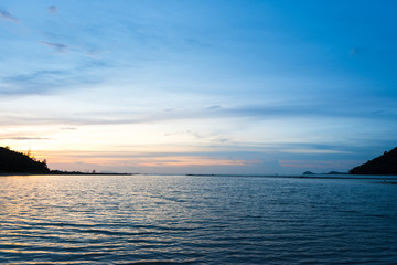 Naklejka na ściany i meble Beautifu twilight sky at sunset over calm tropical sea baach.