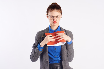 disgruntled girl in a gray cardigan and with a book