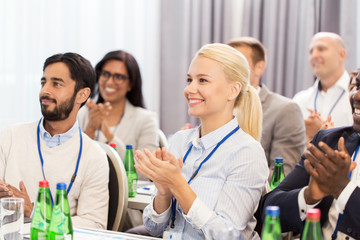 people applauding at business conference