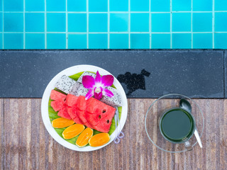 Fresh slice organic fruits and hot green tea