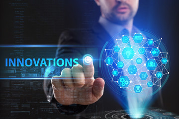 The concept of business, technology, the Internet and the network. A young entrepreneur working on a virtual screen of the future and sees the inscription: Innovations