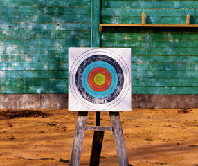 Close up of archery target on green wooden boards background