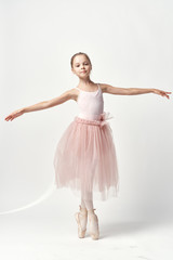 Fototapeta na wymiar little ballerina is dancing on a white background