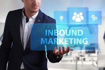 Business, Technology, Internet and network concept. Young businessman working on a virtual screen of the future and sees the inscription: Inbound marketing