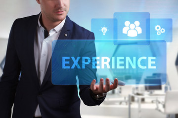 Business, Technology, Internet and network concept. Young businessman working on a virtual screen of the future and sees the inscription: Experience