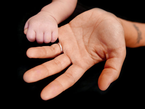 motherhand and babyhand isolated on a black background
