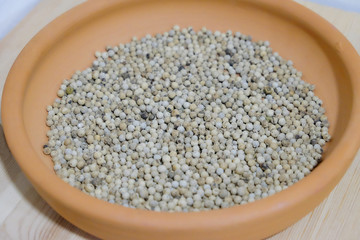 dried white pepper in a dish close up