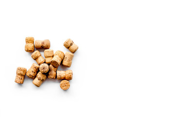 Corks of wine bottles on white background top view copyspace