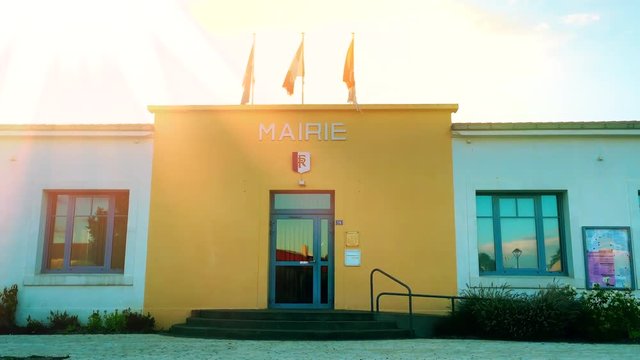 Establishing shot of a typical French Mairie Town Hall in a quiet French Town / Village with National and Regional flags
