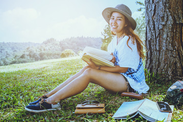 Fototapeta premium Asian women relax in the holiday. Study read a book. Read a book In the garden on the Moutain. In Thailand