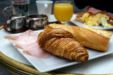 Breakfast with coffee and croissants on table