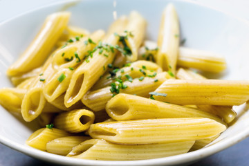 Pasta with pesto sauce and nuts on a the table