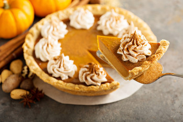 Fototapeta na wymiar Pumpkin pie with whipped cream