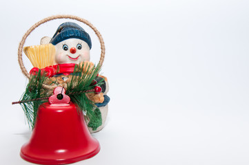 Christmas snowman decoration with red bells, isolated on white background.