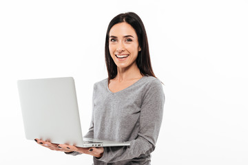 Cheerful woman using laptop computer.
