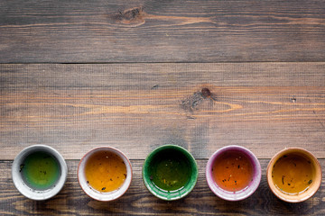 Tea break. Cookware fo tea ceremony. Cups on dark wooden background top view copyspace