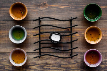 Tea break. Cookware fo tea ceremony. Cups on dark wooden background top view