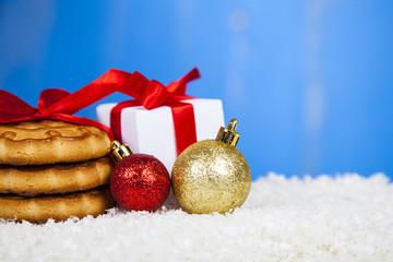 Christmas cookie, gift and balls on snow