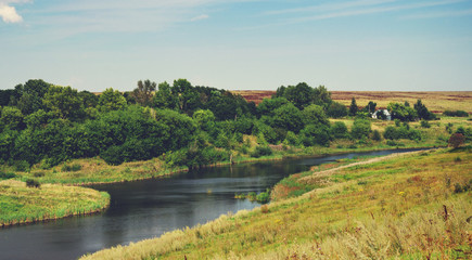 Fototapeta na wymiar Summer countryside landscape with river and lone house