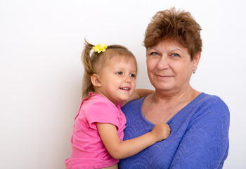 A girl  draws with her grandmother